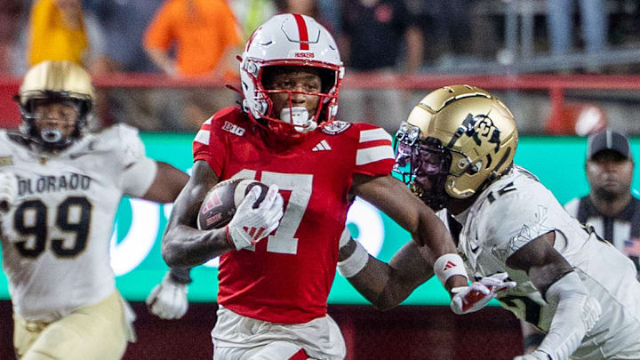 Nebraska wide receiver Jacory Barney Jr. evading 2024 Heisman trophy winner Travis Hunter's tackle. 