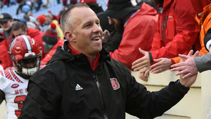 Nov 24, 2018; Chapel Hill, NC, USA; North Carolina State Wolfpack head coach Dave Doeren (left) greets fans after a win against the North Carolina Tar Heels at Kenan Memorial Stadium. The Wolfpack won 34-28 in overtime. Mandatory Credit: Rob Kinnan-Imagn Images