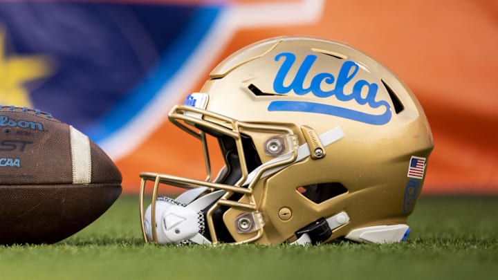 Dec 30, 2022; El Paso, Texas, USA; Helmets of the Pittsburgh Panthers and UCLA Bruins are posed in front of the logo before the 2022 Sun Bowl at Sun Bowl. Mandatory Credit: Ivan Pierre Aguirre-Imagn Images