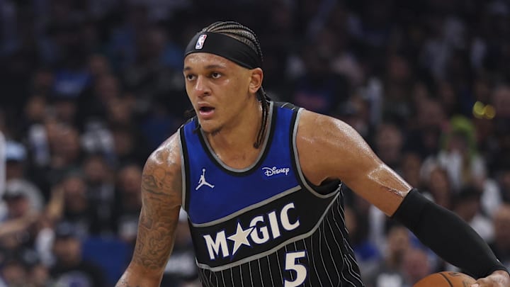 Apr 25, 2026; Orlando, Florida, USA; Orlando Magic forward Paolo Banchero (5) is guarded by Detroit Pistons guard Javonte Green (31) in the third quarter during game three of the first round of the 2026 NBA Playoffs at Kia Center. Mandatory Credit: Nathan Ray Seebeck-Imagn Images