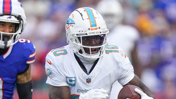 Nov 3, 2024; Orchard Park, New York, USA; Miami Dolphins wide receiver Tyreek Hill (10) runs with the ball against Buffalo Bills safety Taylor Rapp (9) during the second half at Highmark Stadium. Mandatory Credit: Gregory Fisher-Imagn Images