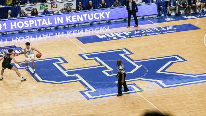 Kentucky-commit Reed Sheppard brings the ball up the court atop the large UK logo.