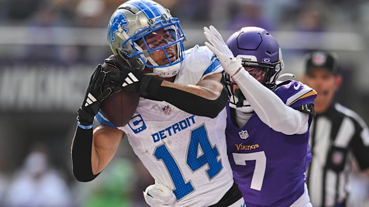 Detroit Lions wide receiver Amon-Ra St. Brown (14) secures reception with Vikings Byron Murphy (7) in coverage