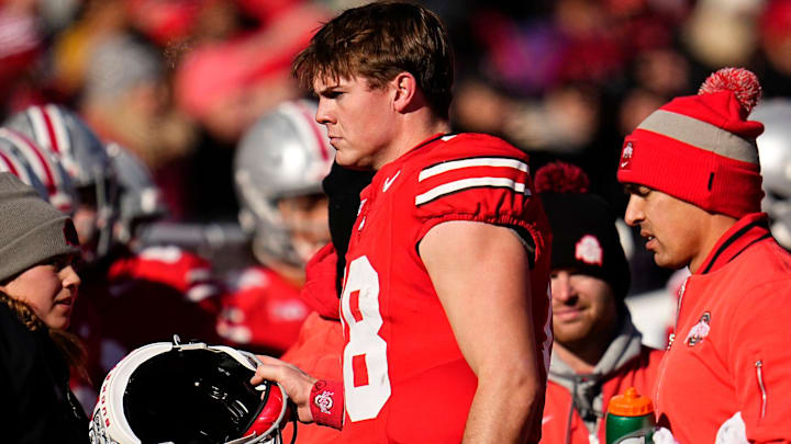 Ohio State Buckeyes quarterback Will Howard (18) leaves the game after a hit from Michigan Wolverines defensive back Makari Paige (7) during the first half of the NCAA football game at Ohio Stadium in Columbus on Saturday, Nov. 30, 2024. Howard returned a few plays later.