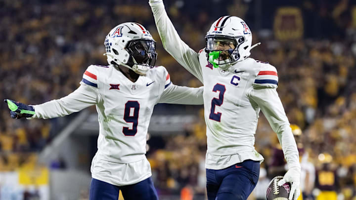 Nov 28, 2025; Tempe, Arizona, USA; Arizona Wildcats defensive back Treydan Stukes (2) celebrates with defensive back Ayden Garnes (9) after an interception against Arizona State Sun Devils in the second half during the 99th Territorial Cup at Mountain America Stadium. Mandatory Credit: Mark J. Rebilas-Imagn Images