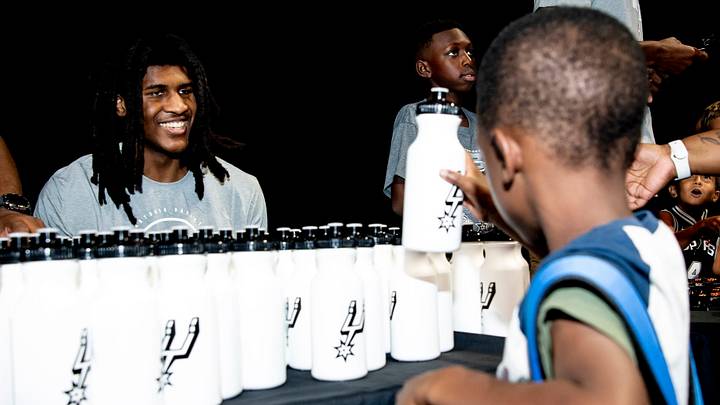 Aug 8, 2026; San Antonio, Texas, USA; San Antonio Spurs center Jayden Quaintance (22) hands out water bottles to families during the team's fifth annual Back to School Bash at Frost Bank Center. Aug 8, 2026; San Antonio, Texas, USA; San Antonio Spurs center Jayden Quaintance (22) hands out water bottles to families during the team's fifth annual Back to School Bash at Frost Bank Center.
