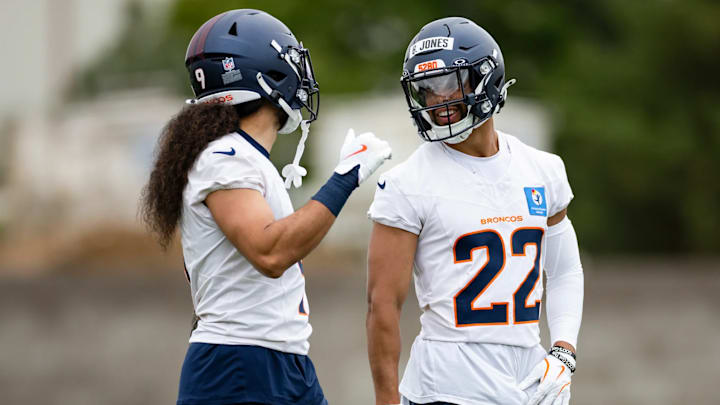 Denver Broncos safeties Talanoa Hufanga (9) and Brandon Jones (22) chat during a voluntary minicamp practice in May of 2025. 