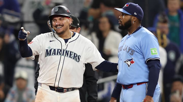 Oct 16, 2025; Seattle, Washington, USA; Seattle Mariners first baseman Josh Naylor (12) reacts in front of Toronto Blue Jays first baseman Vladimir Guerrero Jr. (27) after singling in the ninth inning during game four of the ALCS round for the 2025 MLB playoffs at T-Mobile Park. Mandatory Credit: Kevin Ng-Imagn Images Oct 16, 2025; Seattle, Washington, USA; Seattle Mariners first baseman Josh Naylor (12) reacts in front of Toronto Blue Jays first baseman Vladimir Guerrero Jr. (27) after singling in the ninth inning during game four of the ALCS round for the 2025 MLB playoffs at T-Mobile Park. Mandatory Credit: Kevin Ng-Imagn Images