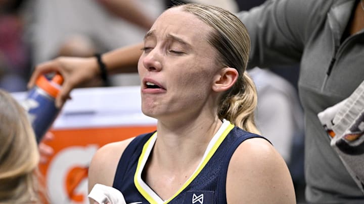 Aug 1, 2025; Dallas, Texas, USA;  Dallas Wings guard Paige Bueckers (5) sits on the team bench after suffering an apparent leg injury during the second half against the Indiana Fever at the American Airlines Center. Mandatory Credit: Jerome Miron-Imagn Images