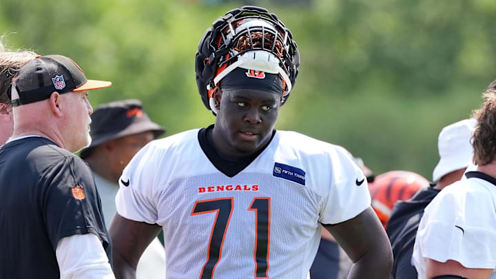 Jul 26, 2024; Cincinnati, OH, USA;  Cincinnati Bengals offensive tackle Amarius Mims (71) talks with offensive line coach Frank Pollack during training camp practice at Kettering Health Practice Fields. Mandatory Credit: Kareem Elgazzar-Imagn Images