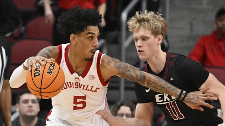 Dec 28, 2024; Louisville, Kentucky, USA;  Louisville Cardinals guard Terrence Edwards Jr. (5) dribbles the ball against Eastern Kentucky Colonels guard Jackson Holt (11) during the first half at KFC Yum! Center. Louisville won 78-76. 