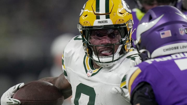 Green Bay Packers running back Josh Jacobs (8) looks for running room against the Minnesota Vikings last season.