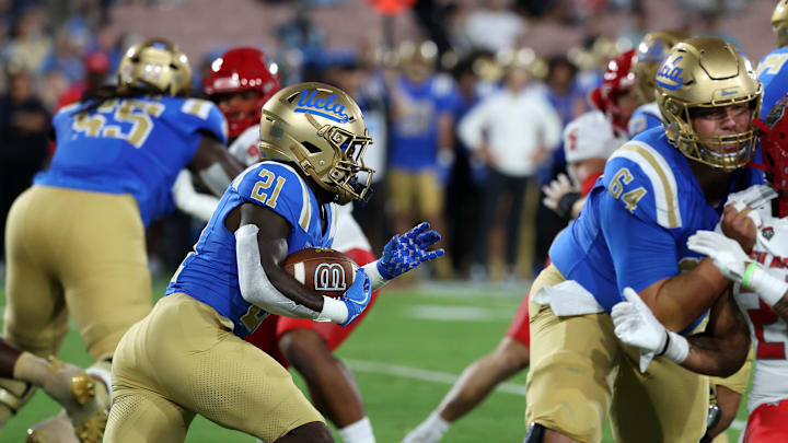 Sep 12, 2025; Pasadena, California, USA; UCLA Bruins running back Jaivian Thomas (21) runs with the ball during the first quarter against the New Mexico Lobos at Rose Bowl. Mandatory Credit: Kiyoshi Mio-Imagn Images Sep 12, 2025; Pasadena, California, USA; UCLA Bruins running back Jaivian Thomas (21) runs with the ball during the first quarter against the New Mexico Lobos at Rose Bowl. Mandatory Credit: Kiyoshi Mio-Imagn Images