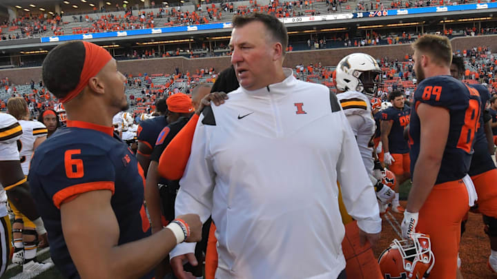 Aug 27, 2022; Champaign, Illinois, USA; Illinois Fighting Illini head coach Bret Bielema gets a hand from defensive back Terrell Jennings (6) after Saturday s win over the Wyoming Cowboys at Memorial Stadium. Mandatory Credit: Ron Johnson-Imagn Images