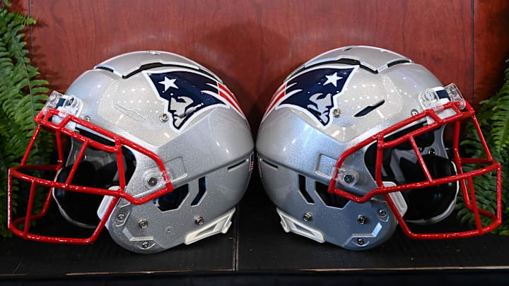 Jan 13, 2025; Foxborough, MA, USA; A pair of New England Patriots helmets sit in front of the podium before a press conference at Gillette Stadium. Mandatory Credit: Eric Canha-Imagn Images