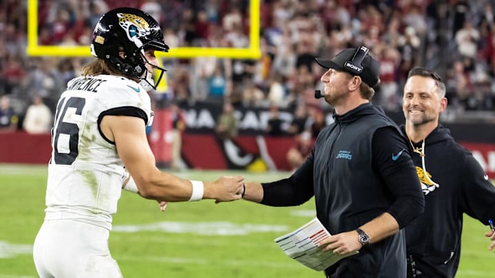 Nov 23, 2025; Glendale, Arizona, USA; Jacksonville Jaguars quarterback Trevor Lawrence (16) celebrates with head coach Liam Coen after defeating the Arizona Cardinals at State Farm Stadium. Mandatory Credit: Mark J. Rebilas-Imagn Images Nov 23, 2025; Glendale, Arizona, USA; Jacksonville Jaguars quarterback Trevor Lawrence (16) celebrates with head coach Liam Coen after defeating the Arizona Cardinals at State Farm Stadium. Mandatory Credit: Mark J. Rebilas-Imagn Images