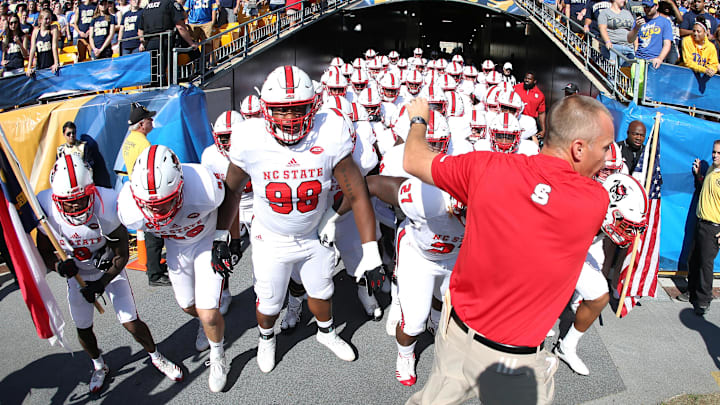 Oct 14, 2017; Pittsburgh, PA, USA; North Carolina State Wolfpack head coach Dave Doeren (front) leads the team out of the tunnel to play the Pittsburgh Panthers at Heinz Field. Mandatory Credit: Charles LeClaire-Imagn Images Oct 14, 2017; Pittsburgh, PA, USA; North Carolina State Wolfpack head coach Dave Doeren (front) leads the team out of the tunnel to play the Pittsburgh Panthers at Heinz Field. Mandatory Credit: Charles LeClaire-Imagn Images