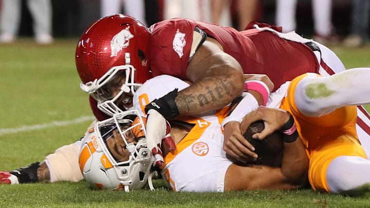Arkansas Razorbacks defensive lineman Cameron Ball (5) sacks Tennessee Volunteers quarterback Nico Iamaleava (8) during the second quarter at Donald W. Reynolds Razorback Stadium.