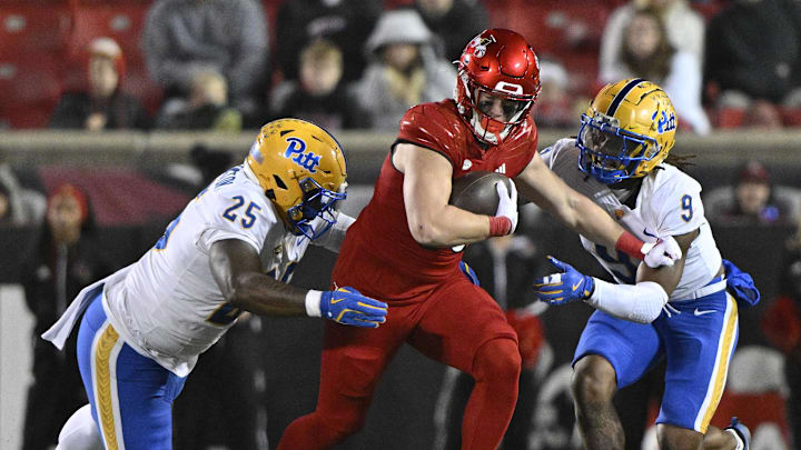 Nov 23, 2024; Louisville, Kentucky, USA; Louisville Cardinals tight end Nate Kurisky (85) runs against Pittsburgh Panthers defensive lineman Jahsear Whittington (25) and linebacker Kyle Louis (9) during the second half at L&N Federal Credit Union Stadium. Louisville defeated Pittsburgh 37-9. Mandatory Credit: Jamie Rhodes-Imagn Images Nov 23, 2024; Louisville, Kentucky, USA; Louisville Cardinals tight end Nate Kurisky (85) runs against Pittsburgh Panthers defensive lineman Jahsear Whittington (25) and linebacker Kyle Louis (9) during the second half at L&N Federal Credit Union Stadium. Louisville defeated Pittsburgh 37-9. Mandatory Credit: Jamie Rhodes-Imagn Images