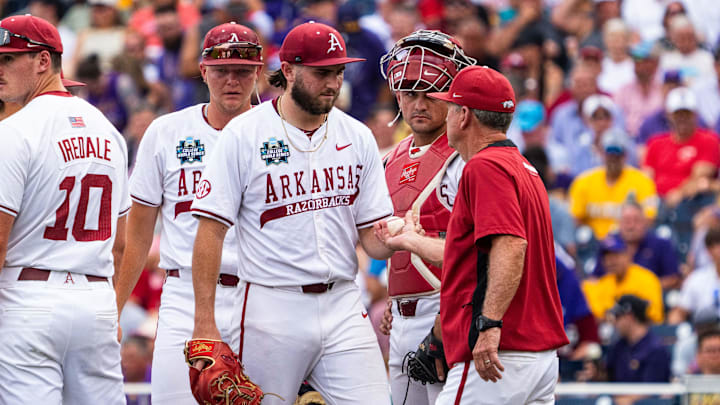 Arkansas Razorbacks starting pitcher Zach Root hands the ball to Hogs coach Dave Van Horn after being pulled in the second inning of Saturday night's 4-1 loss to the LSU Tigers at Charles Schwab Field in Omaha, Neb. Arkansas Razorbacks starting pitcher Zach Root hands the ball to Hogs coach Dave Van Horn after being pulled in the second inning of Saturday night's 4-1 loss to the LSU Tigers at Charles Schwab Field in Omaha, Neb.