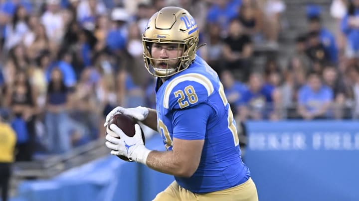 Oct 12, 2024; Pasadena, California, USA; UCLA Bruins tight end Jack Pedersen (28) catches a pass against the Minnesota Golden Gophers during the first quarter at Rose Bowl. Mandatory Credit: Robert Hanashiro-Imagn Images
