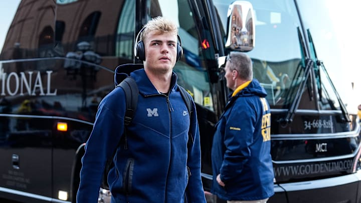Michigan quarterback Davis Warren (16) walks off the bus during team arrival before the Michigan State game at Michigan Stadium in Ann Arbor on Saturday, Oct. 26, 2024.