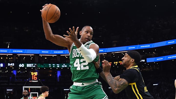 Mar 3, 2024; Boston, Massachusetts, USA;  Boston Celtics center Al Horford (42) controls the ball while Golden State Warriors guard Gary Payton II (0) defends during the first half at TD Garden. Mandatory Credit: Bob DeChiara-Imagn Images