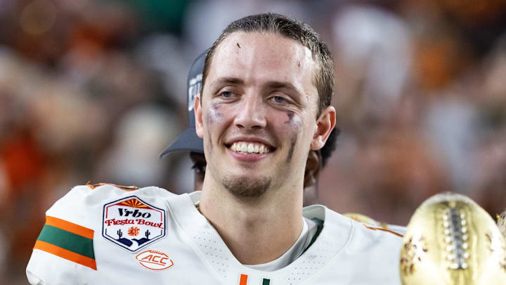 Jan 8, 2026; Glendale, AZ, USA; Miami Hurricanes quarterback Carson Beck (11) celebrates with the trophy after defeating the Mississippi Rebels during the 2026 Fiesta Bowl and semifinal game of the College Football Playoff at State Farm Stadium. Mandatory Credit: Mark J. Rebilas-Imagn Images