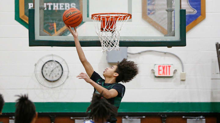 Washington sophomore Steven Reynolds puts up a reverse layup during a Class 3A, Sectional 19 boys basketball quarterfinal game against Marian Tuesday, Feb. 27, 2024, at Washington High School in South Bend.