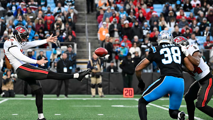 Dec 1, 2024; Charlotte, North Carolina, USA;  Tampa Bay Buccaneers punter Trenton Gill (16) punts in the second quarter at Bank of America Stadium. Mandatory Credit: Bob Donnan-Imagn Images