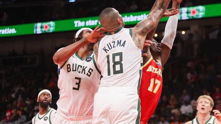 Mar 14, 2026; Atlanta, Georgia, USA; Atlanta Hawks forward Onyeka Okongwu (17) and Milwaukee Bucks center Myles Turner (3) and forward Kyle Kuzma (18) go up for a rebound in the third quarter at State Farm Arena. Mandatory Credit: Brett Davis-Imagn Images