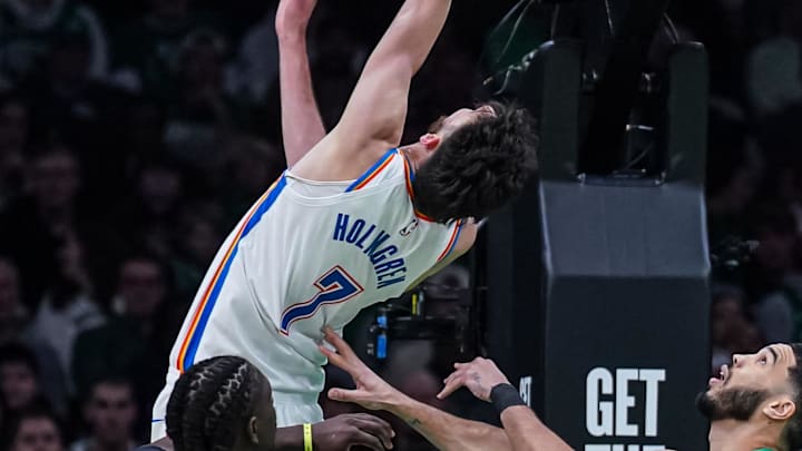 Mar 12, 2025; Boston, Massachusetts, USA; Oklahoma City Thunder forward Chet Holmgren (7) scores against Boston Celtics forward Jayson Tatum (0) in the second quarter at TD Garden. Mandatory Credit: David Butler II-Imagn Images