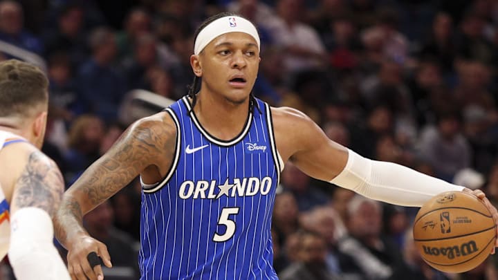 Mar 17, 2026; Orlando, Florida, USA; Orlando Magic forward Paolo Banchero (5) is guarded by Oklahoma City Thunder center Isaiah Hartenstein (55) in the first quarter at Kia Center. Mandatory Credit: Nathan Ray Seebeck-Imagn Images