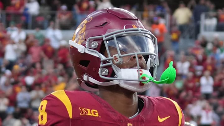 Nov 30, 2024; Los Angeles, California, USA; Southern California Trojans wide receiver Ja'Kobi Lane (8) celebrates after scoring on a 6-yard touchdown reception against the Notre Dame Fighting Irish in the second half at United Airlines Field at Los Angeles Memorial Coliseum. Mandatory Credit: Kirby Lee-Imagn Images