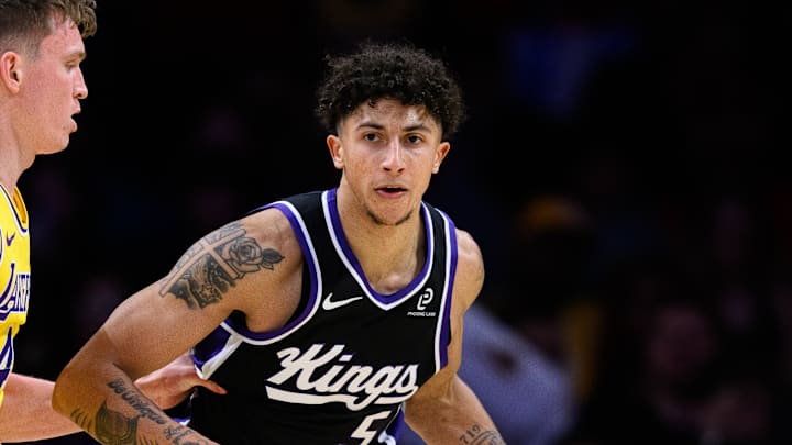 Oct 17, 2025; Los Angeles, California, USA; Sacramento Kings guard Nique Clifford (5) controls the ball while under pressure from Los Angeles Lakers forward Dalton Knecht (4) during the second half at Crypto.com Arena. Mandatory Credit: William Liang-Imagn Images