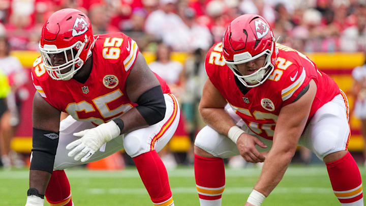 Sep 14, 2025; Kansas City, Missouri, USA; Kansas City Chiefs offensive tackle Jawaan Taylor (74) and guard Trey Smith (65) and center Creed Humphrey (52) at the line of scrimmage against the Philadelphia Eagles during the game at GEHA Field at Arrowhead Stadium. Mandatory Credit: Denny Medley-Imagn Images