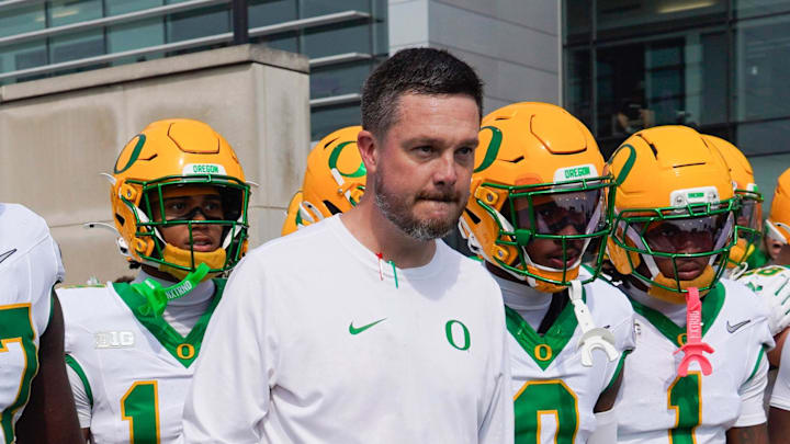 Sep 13, 2025; Evanston, Illinois, USA; Oregon Ducks head coach Dan Lanning leads his team on the field against the Northwestern Wildcats at Northwestern Medicine Field at Martin Stadium. Mandatory Credit: David Banks-Imagn Images