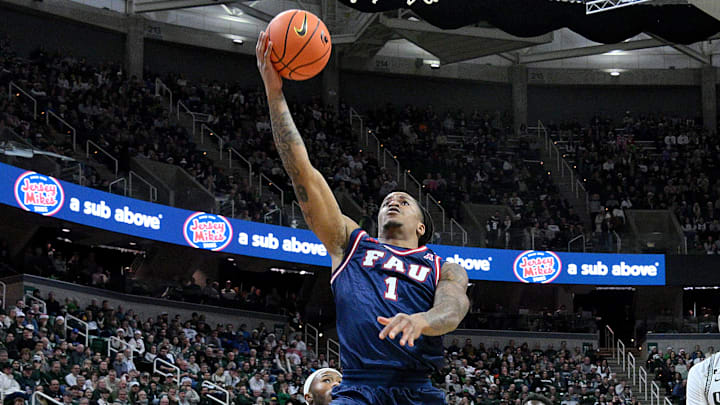 Dec 21, 2024; East Lansing, Michigan, USA;  Florida Atlantic Owls forward Kaleb Glenn (1) scores on a steal during the first half against the Michigan State Spartans at Jack Breslin Student Events Center. Mandatory Credit: Dale Young-Imagn Images