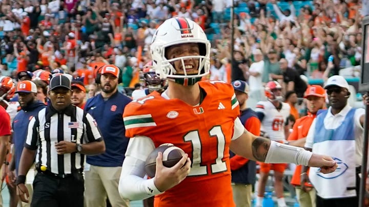 Nov 8, 2025; Miami Gardens, Florida, USA; Miami Hurricanes quarterback Carson Beck (11) catches a touchdown pass against the Syracuse Orange during the second quarter at Hard Rock Stadium. Mandatory Credit: Jeff Romance-Imagn Images