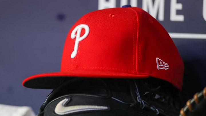 May 26, 2023; Atlanta, Georgia, USA; A detailed view of a Philadelphia Phillies hat and glove on the bench against the Atlanta Braves in the seventh inning at Truist Park. 