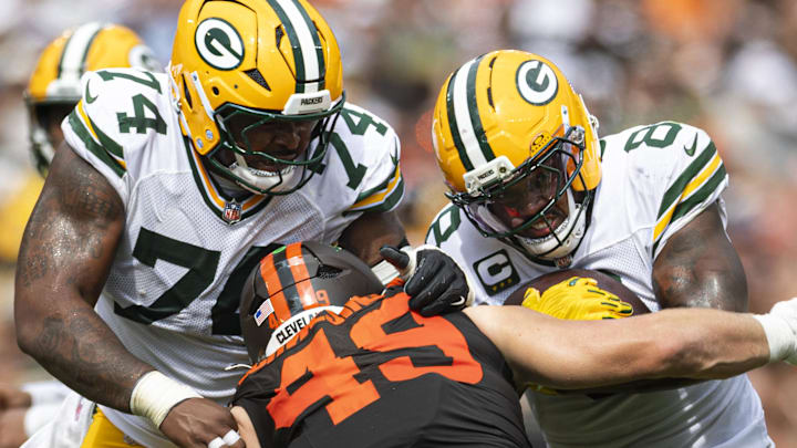 Green Bay Packers running back Josh Jacobs (8) runs the ball as Elgton Jenkins blocks Browns linebacker Carson Schwesinger. Green Bay Packers running back Josh Jacobs (8) runs the ball as Elgton Jenkins blocks Browns linebacker Carson Schwesinger.