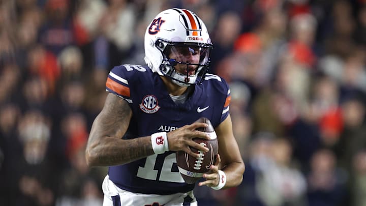 Nov 29, 2025; Auburn, Alabama, USA; Auburn Tigers quarterback Ashton Daniels (12) runs with the ball during the first half against the Alabama Crimson Tide at Jordan-Hare Stadium. Mandatory Credit: John Reed-Imagn Images
