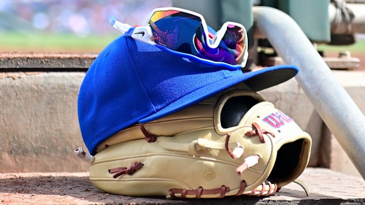 Feb 27, 2024; Mesa, Arizona, USA;  General view of a Chicago Cubs glove, hat and glasses in the first inning against the Cincinnati Reds during a spring training game at Sloan Park. 