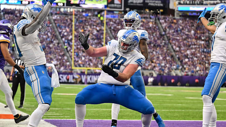 Former Lions running back Jamaal Williams (left) and offensive tackle Dan Skipper (70) celebrate touchdown