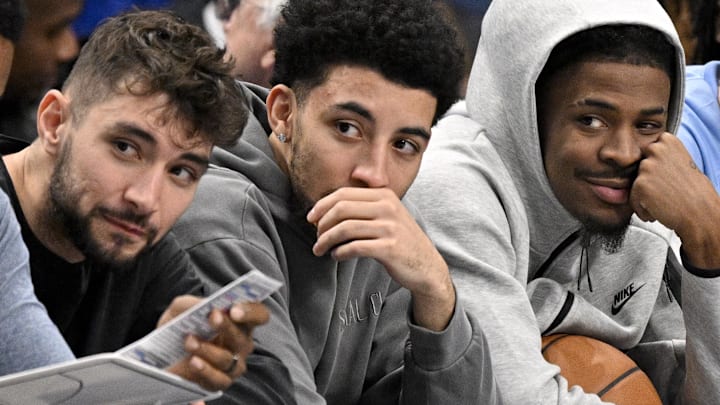 Nov 22, 2025; Dallas, Texas, USA; Memphis Grizzlies guard Ja Morant (center) looks on from the team bench during the first quarter against the Dallas Mavericks at the American Airlines Center. Mandatory Credit: Jerome Miron-Imagn Images