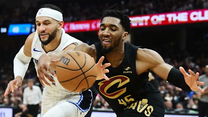 May 5, 2024; Cleveland, Ohio, USA; Cleveland Cavaliers guard Donovan Mitchell (45) goes for a loose ball against Orlando Magic guard Jalen Suggs (4) during the first half in game seven of the first round for the 2024 NBA playoffs at Rocket Mortgage FieldHouse. Mandatory Credit: Ken Blaze-Imagn Images