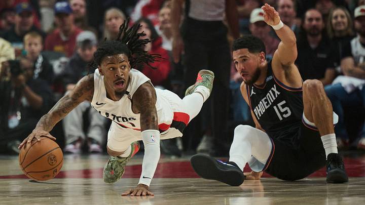 Oct 21, 2026: Portland Trail Blazers guard Ja Morant dives after a loose ball during the first half against Phoenix Suns guard Devin Booker at Moda Center. Mandatory Credit: Troy Wayrynen
