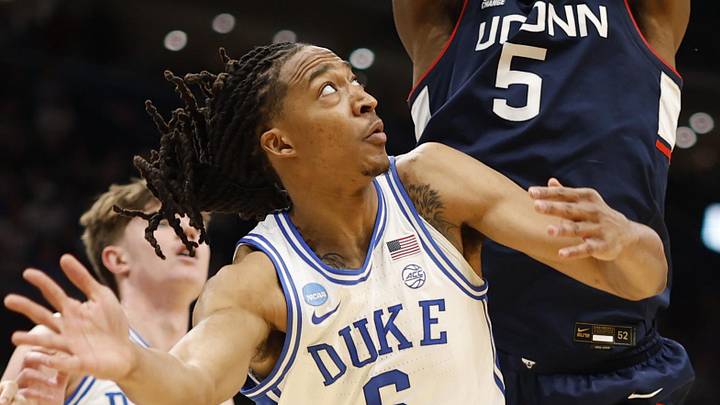 Mar 29, 2026; Washington, DC, USA; UConn Huskies forward Tarris Reed Jr. (5) rebounds over Duke Blue Devils forward Maliq Brown (6) during an Elite Eight game of the East Regional of the men's 2026 NCAA Tournament at Capital One Arena. Mandatory Credit: Geoff Burke-Imagn Images