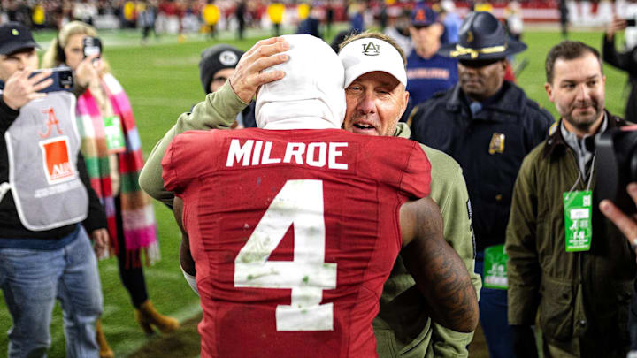 Auburn Tigers head coach Hugh Freeze hugs Alabama Crimson Tide quarterback Jalen Milroe after the 2024 Iron Bowl