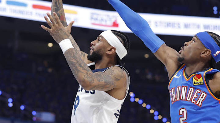 May 22, 2025; Oklahoma City, Oklahoma, USA; Minnesota Timberwolves guard Nickeil Alexander-Walker (9) shoots against Oklahoma City Thunder guard Shai Gilgeous-Alexander (2) in the third quarter during game two of the western conference finals for the 2025 NBA Playoffs at Paycom Center. Mandatory Credit: Alonzo Adams-Imagn Images